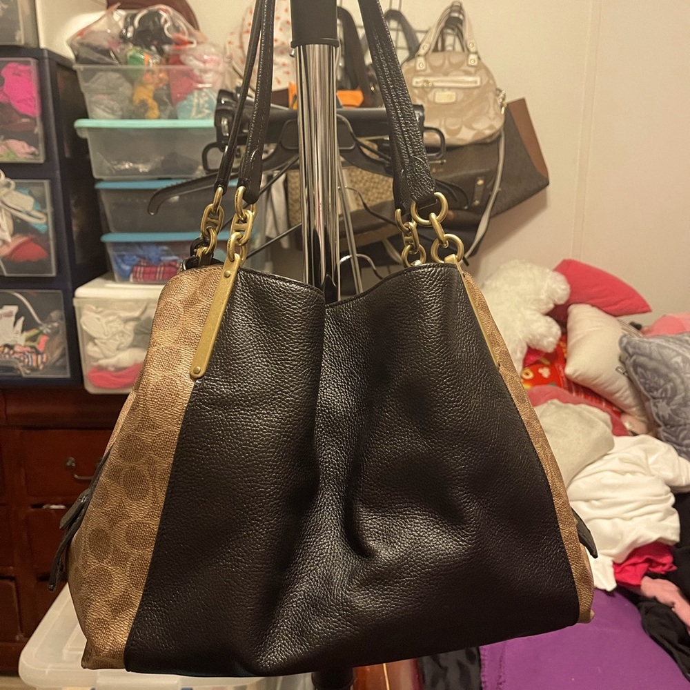 Black,brown,tan large coach purse with a lot of pockets and space.